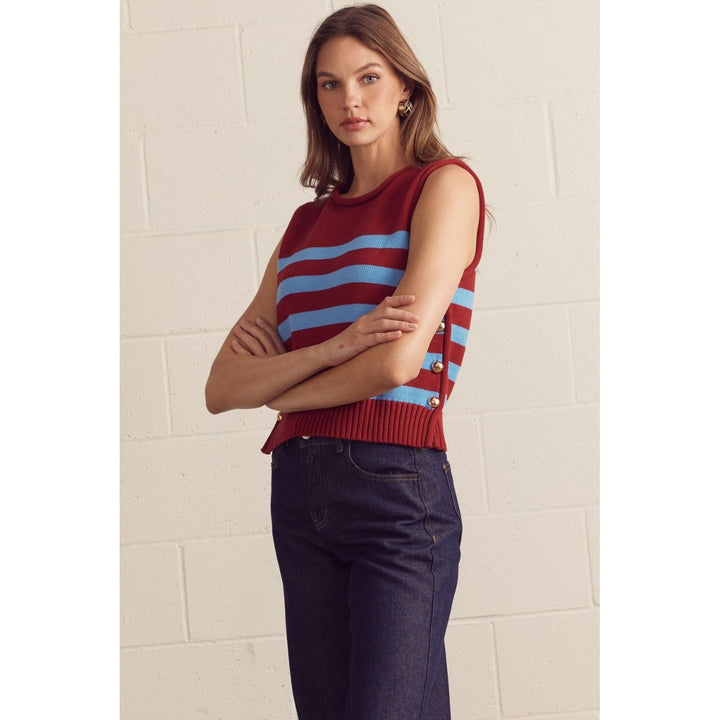 The Pearl Pagoda burgundy and powder-blue striped cotton sweater vest with gold-tone side buttons on a model.